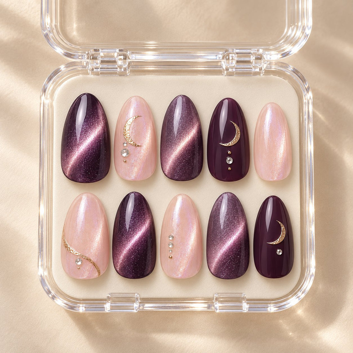 Amethyst Moon Celestial Nails With Gold Crescents and Crystal Accents in clear acrylic storage box