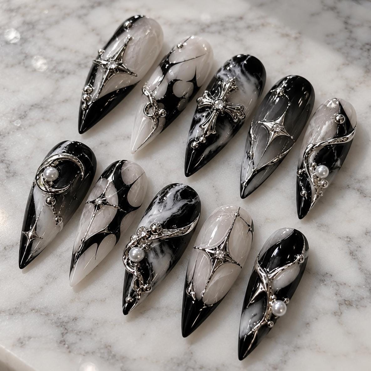 Black and Silver Marble Nails with Chrome Accents, Cross Charms and Rhinestones