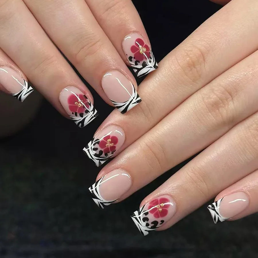 Black and White Patterned French Tip Nails With Red Flowers and Gold Accents