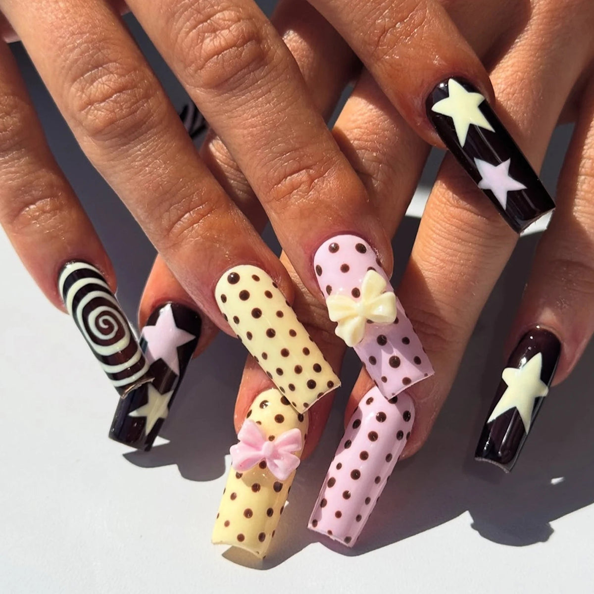 Black, Pink and Yellow Y2K Nails with Stars, Polka Dots and 3D Bows