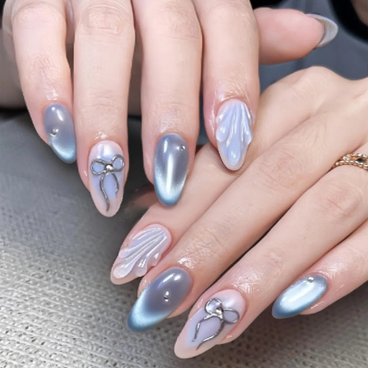 Blue Gray Cat Eye Nails with Silver Bows and Sculpted Shell Details