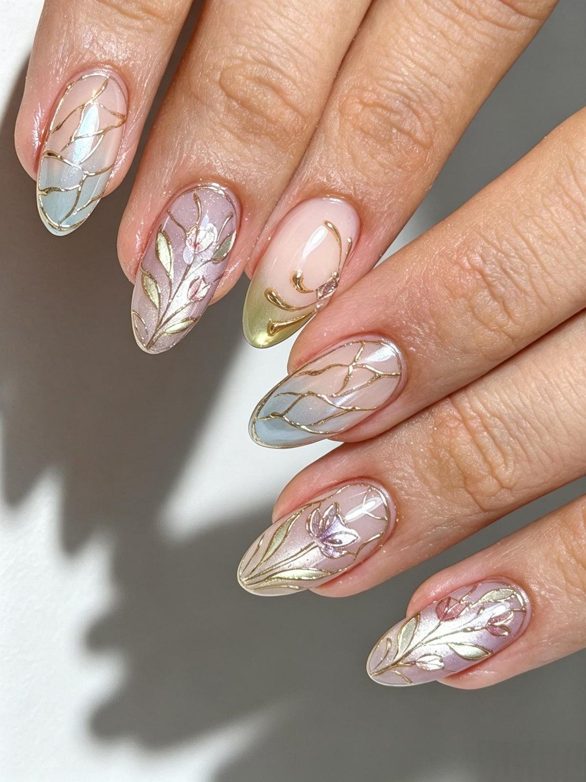 Blush Ombre Bridal Nails with Gold Veins, Floral Details, and Tiny Stones
