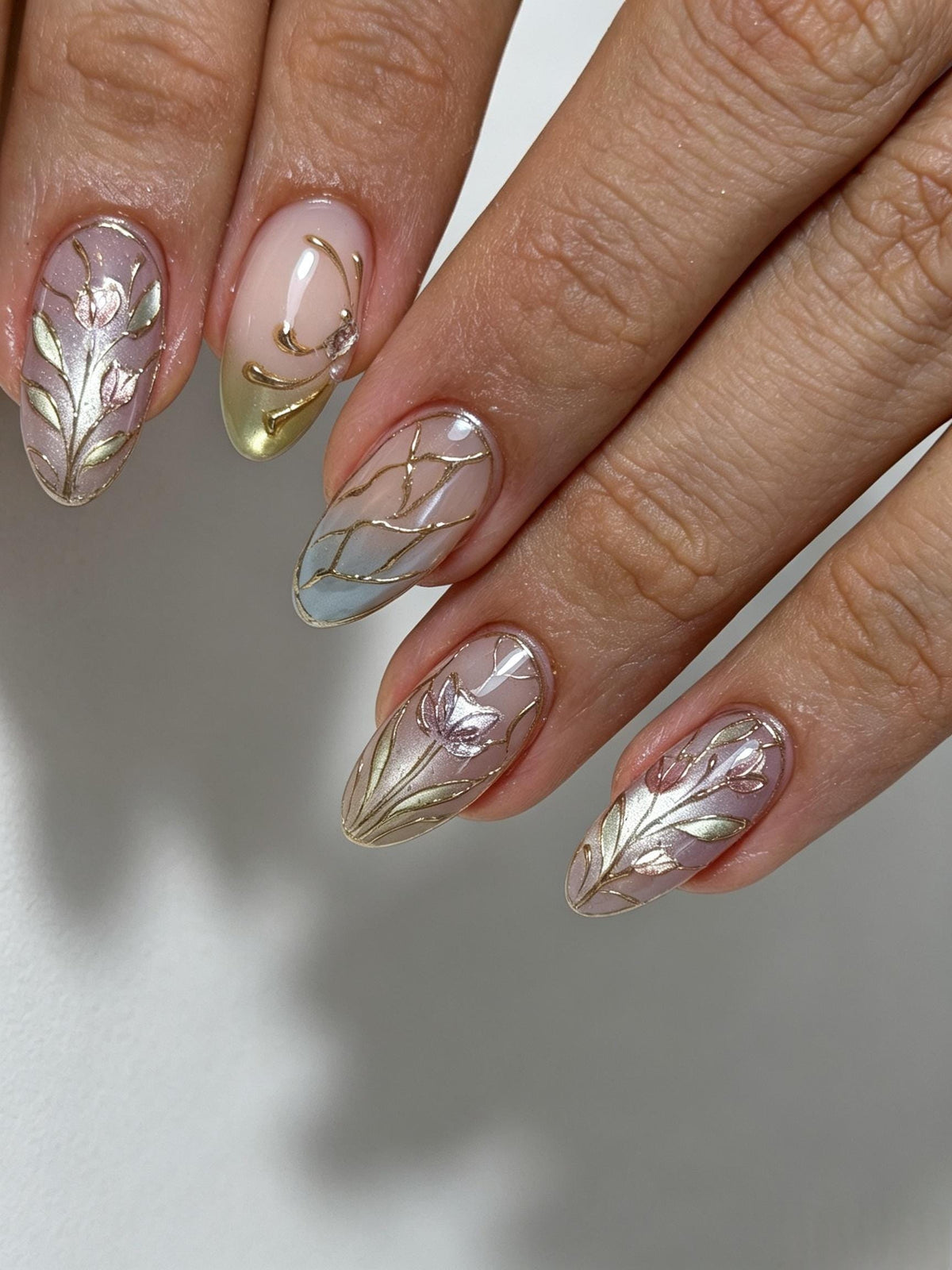 Blush Ombre Bridal Nails with Gold Veins, Floral Details, and Tiny Stones