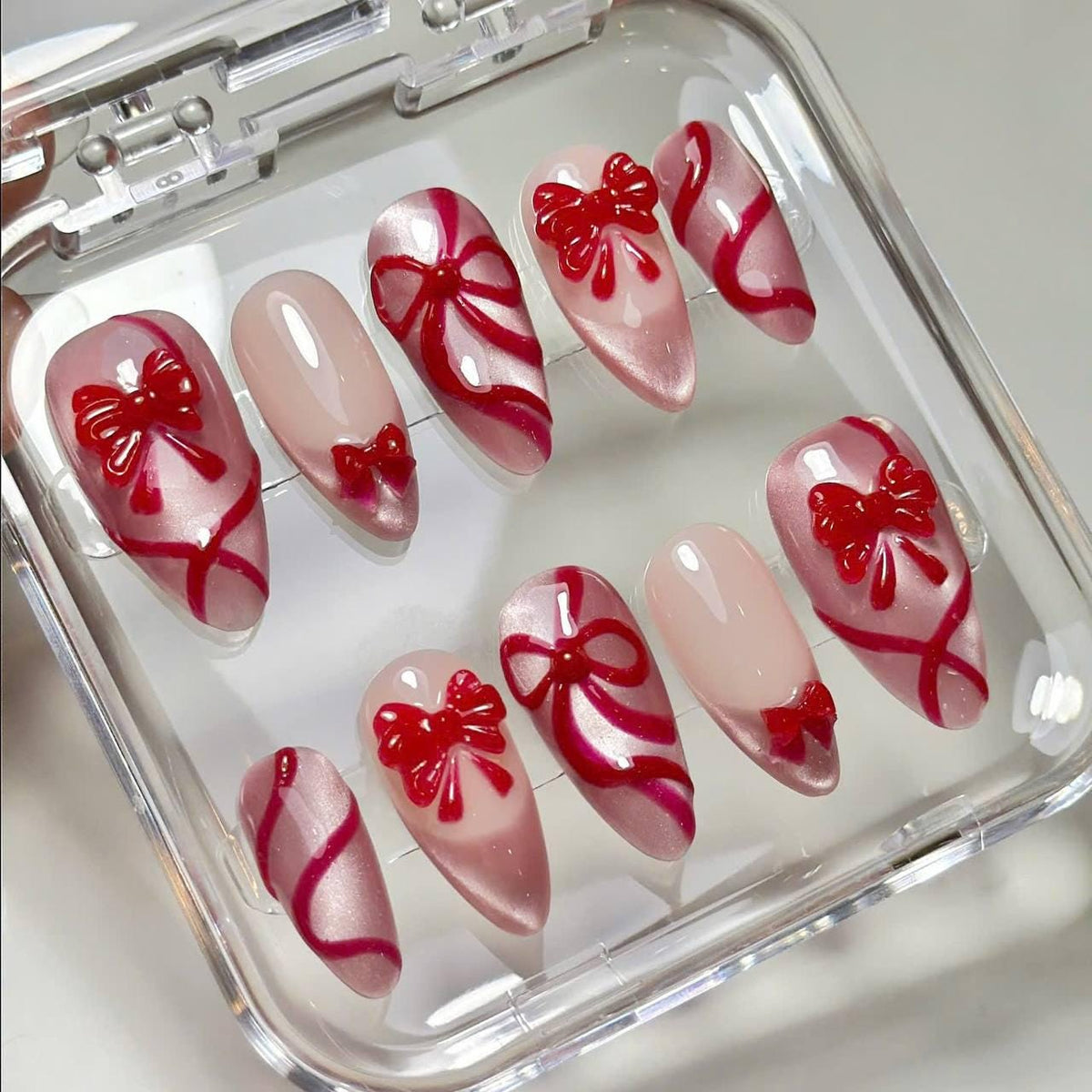 Blush Pink Christmas Press-On Nails With Raised Red Bows and Ribbon Details