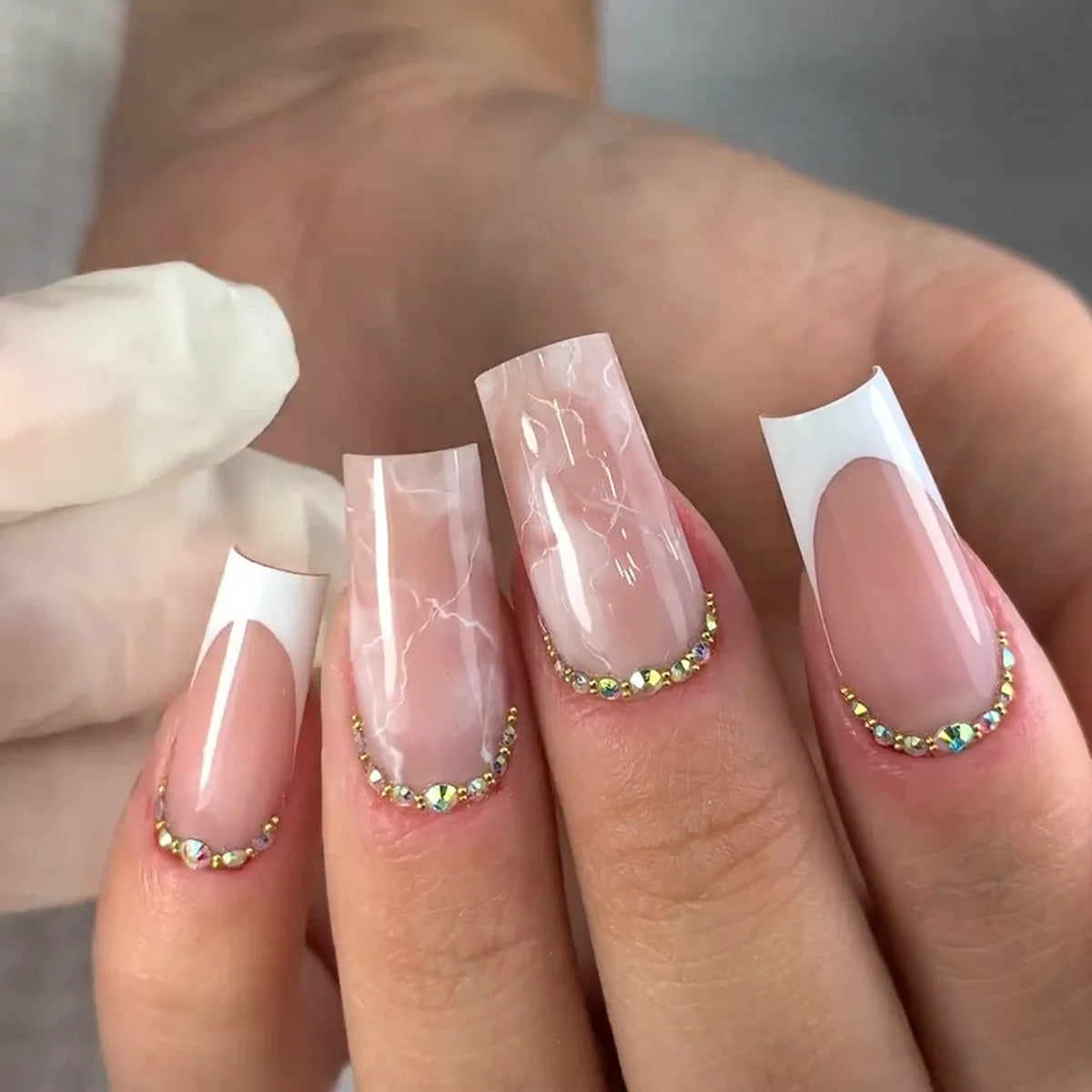Blush Pink French Tip Nails with Marbled Accents and Rhinestones