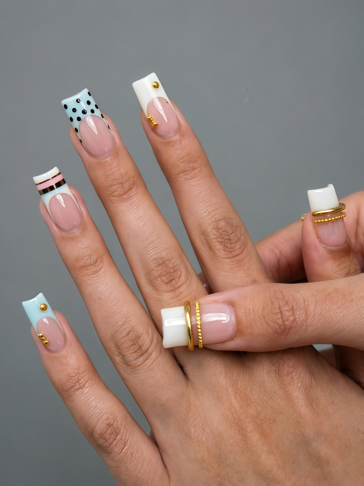 Blush Pink French Tip Nails With Polka Dots, Stripes, and Gold Studs