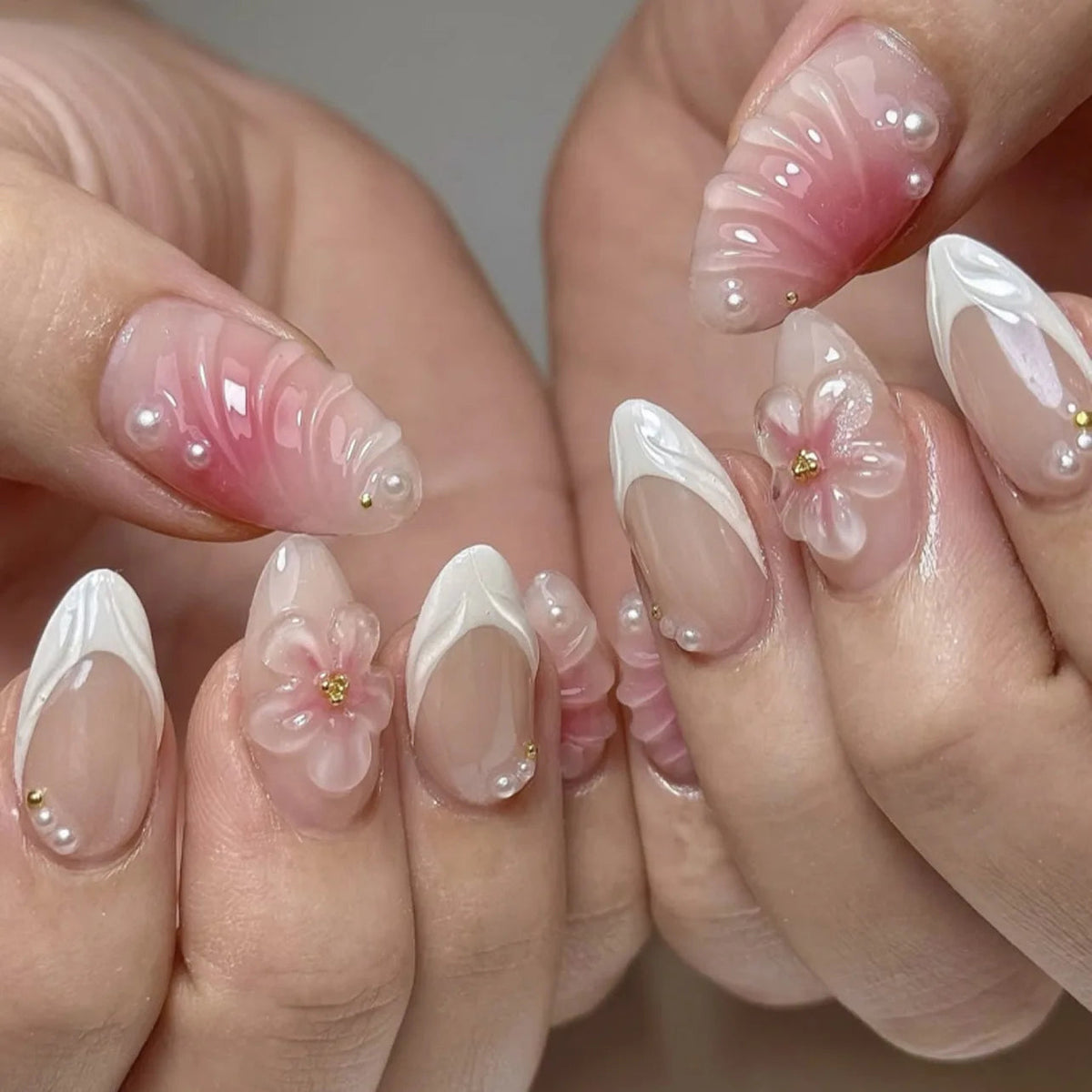 Blush Pink French Tip Nails With Sculpted Flowers and Pearl Accents