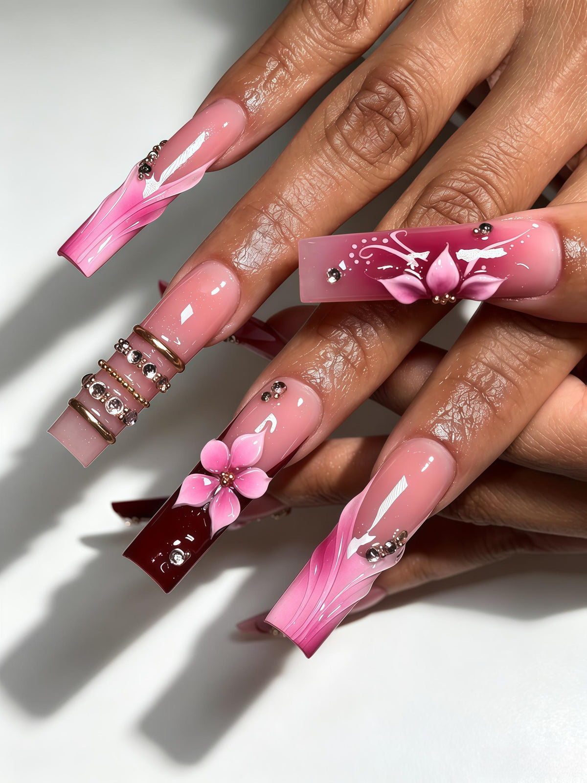 Blush Pink Marbled Tip Nails with 3D Flowers, Burgundy Accents, Gold Bands and Rhinestones