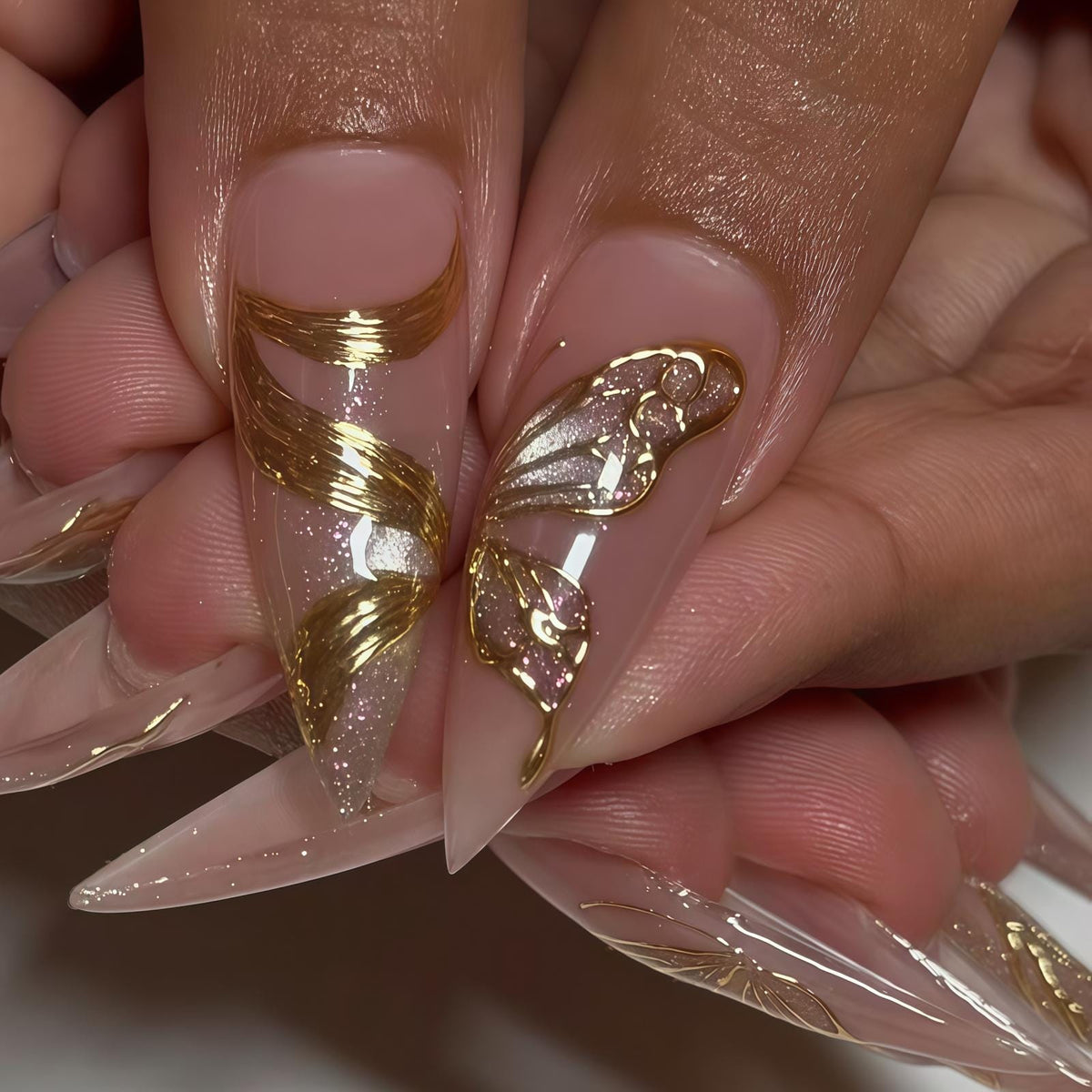 Blush Pink Nails With Ornate Gold Swirls and Reflective Accents