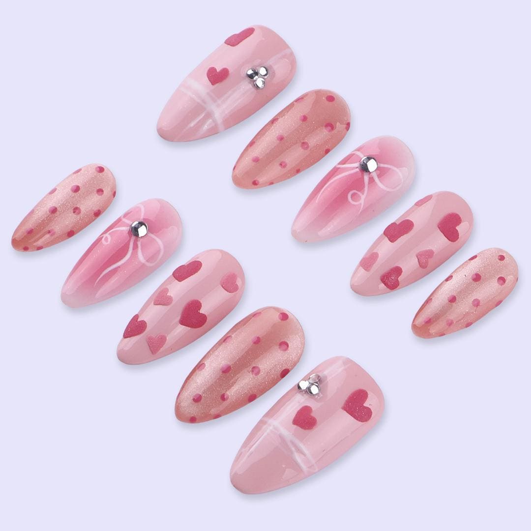 Blush Pink Valentine Nails with Hearts, Polka Dots, and Rhinestone Bows