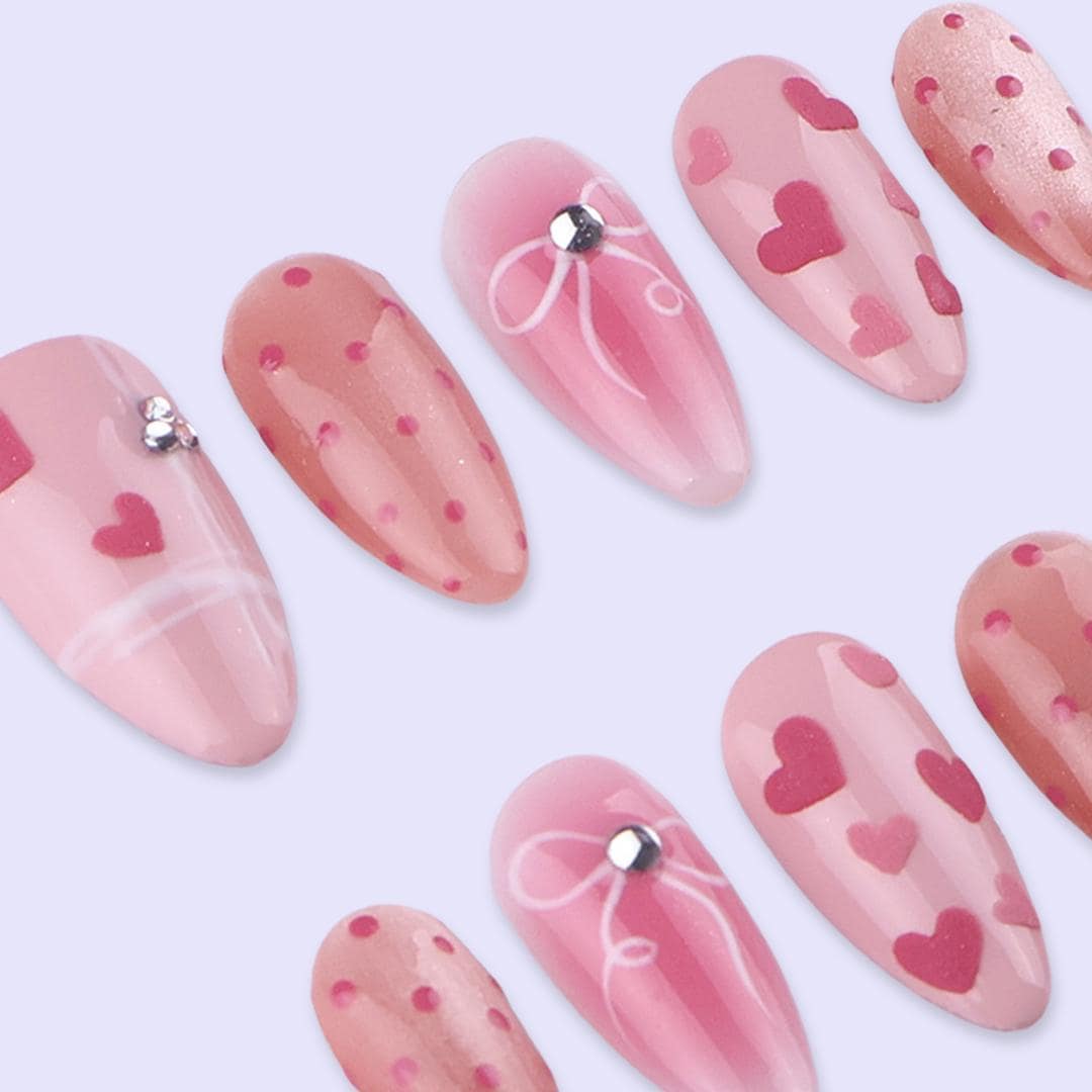 Blush Pink Valentine Nails with Hearts, Polka Dots, and Rhinestone Bows