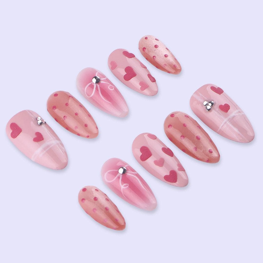 Blush Pink Valentine Nails with Hearts, Polka Dots, and Rhinestone Bows