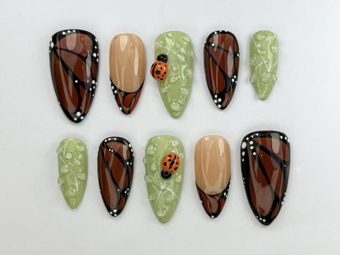 Brown and Black Wing-Inspired Press On Nails With Green Dewdrops and Ladybugs