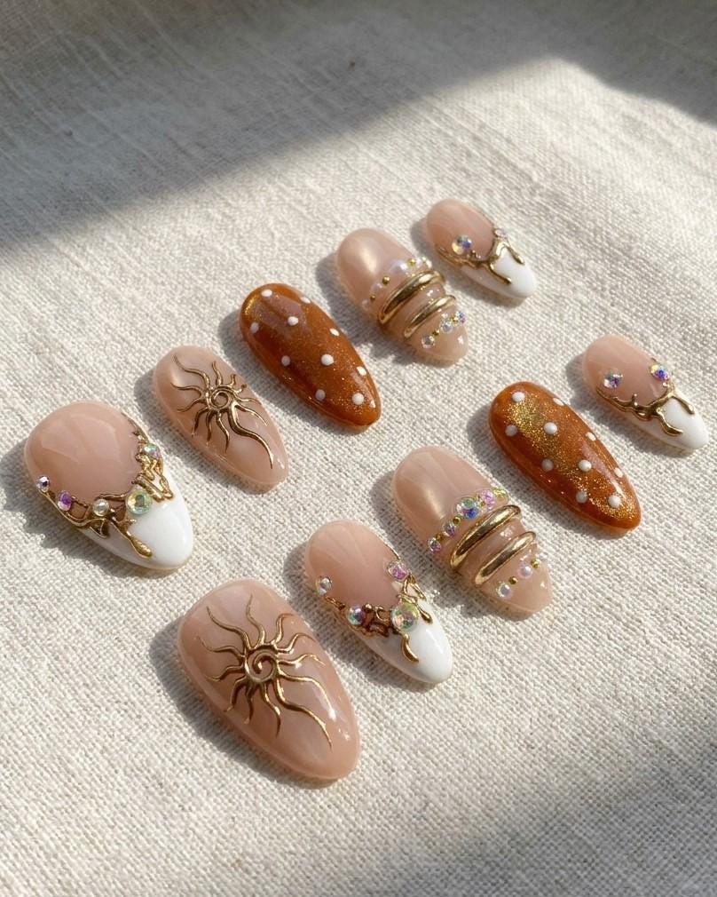 Brown Cat Eye and Blush French Tip Nails with Gold Sun Details