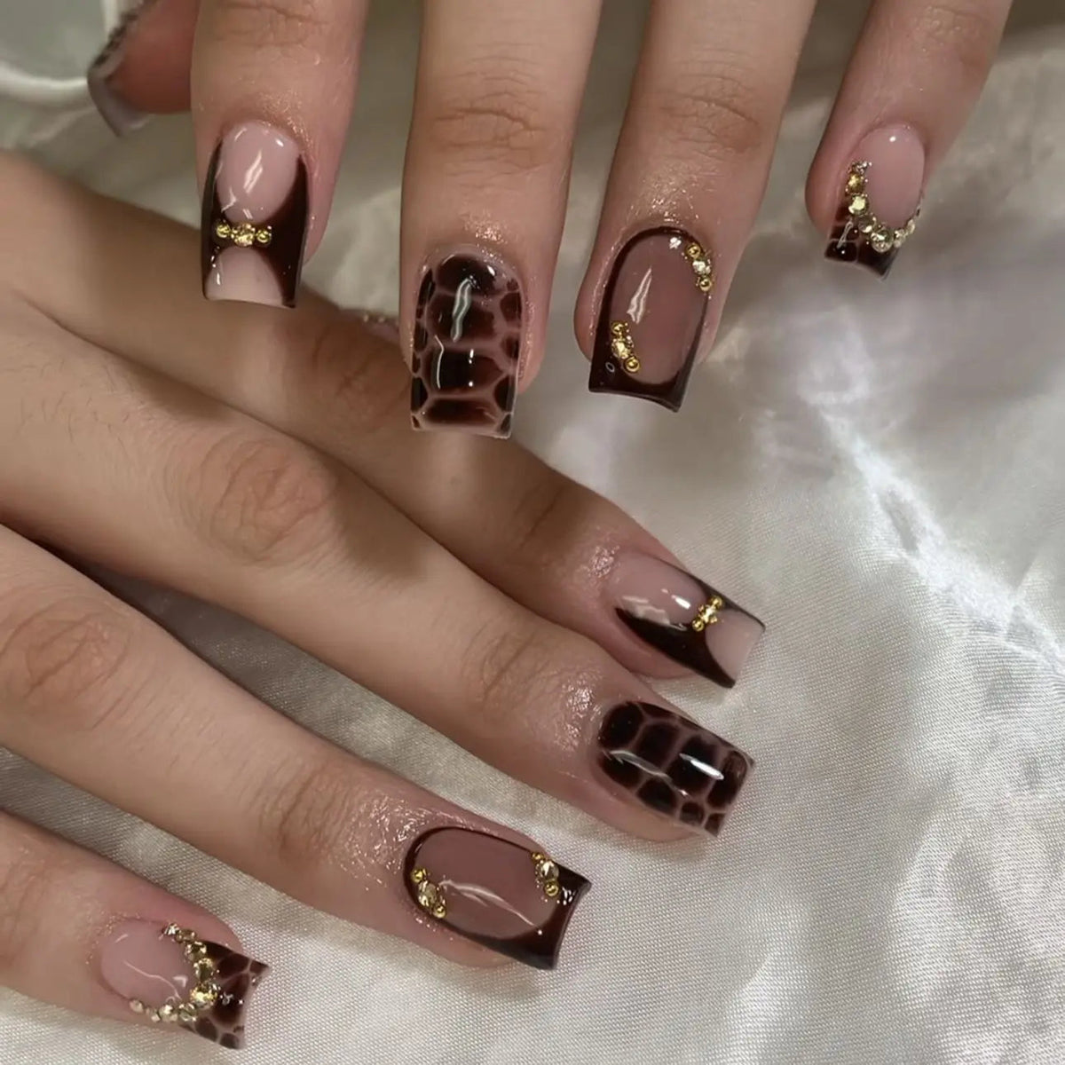 Brown Checkerboard French Tip Nails with Gold Details and Rhinestones