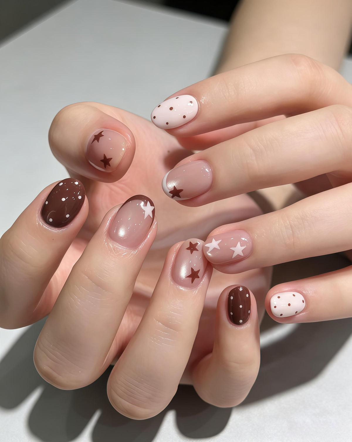 Brown Star and Polka Dot Nails With Nude Pink Cat-Eye Base