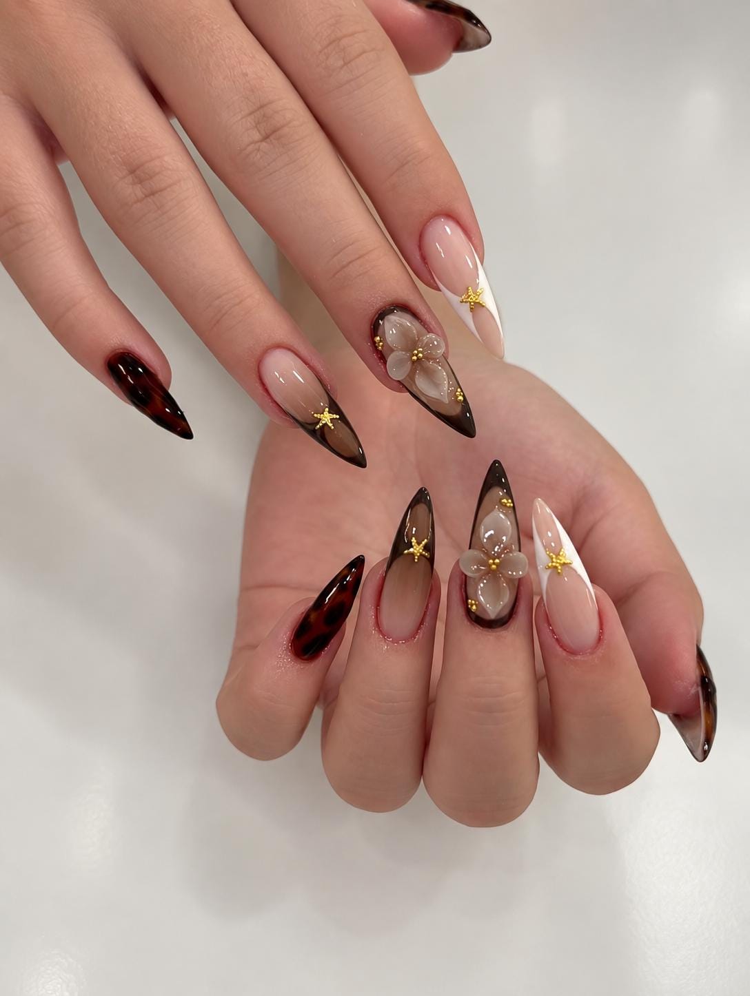 Brown Tortoiseshell French Tip Nails With 3D Flowers and Gold Stars