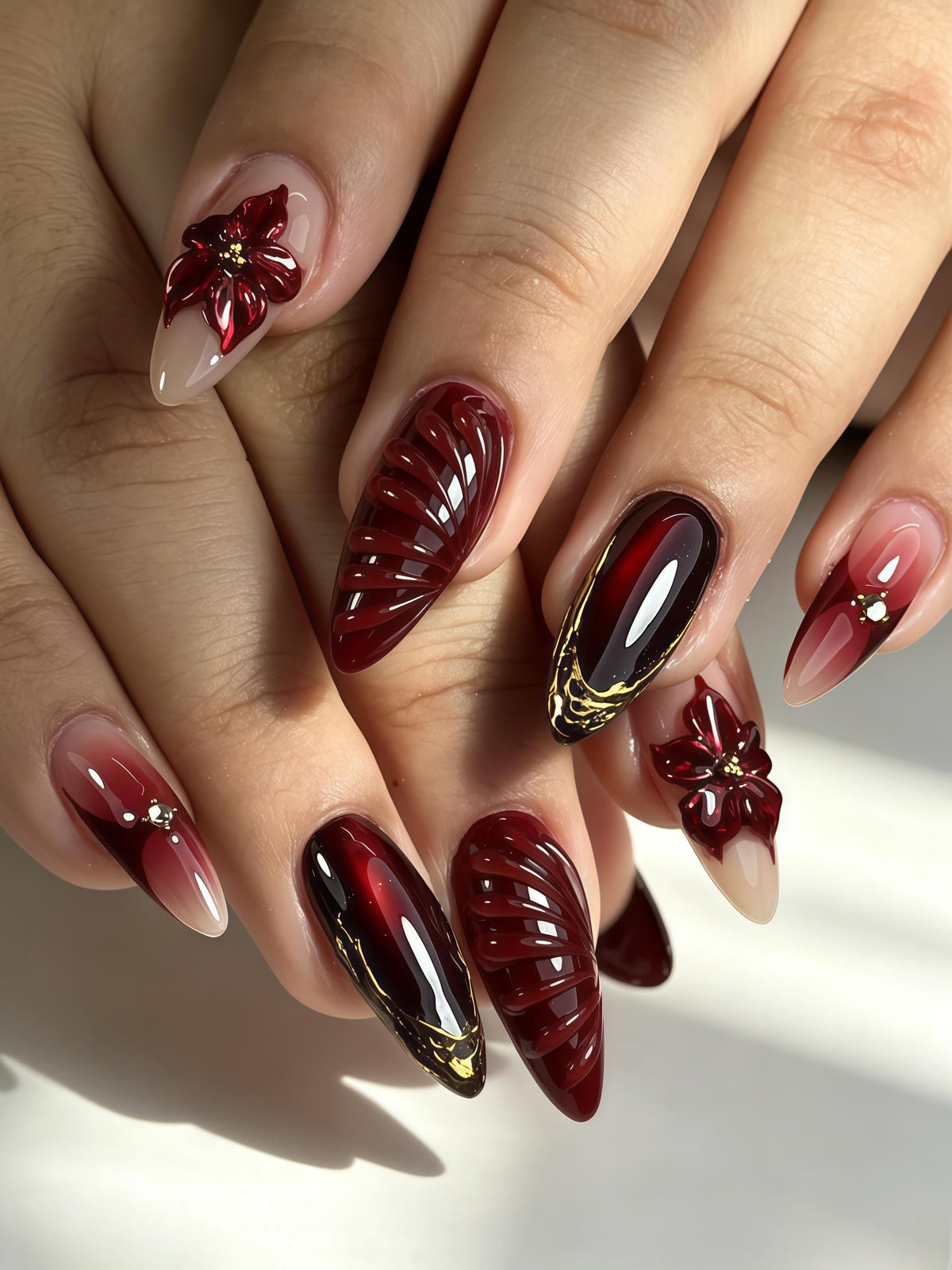 Burgundy 3D Flower Nails With Black, Nude Pink, and Gold Accents