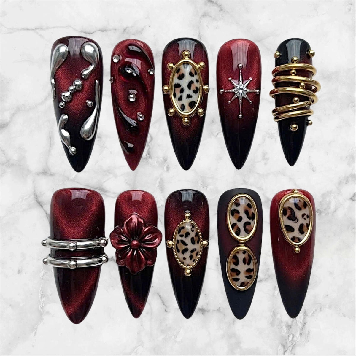 Burgundy and Black Cat-Eye Nails with Leopard Print, Metal Accents, and 3D Flower