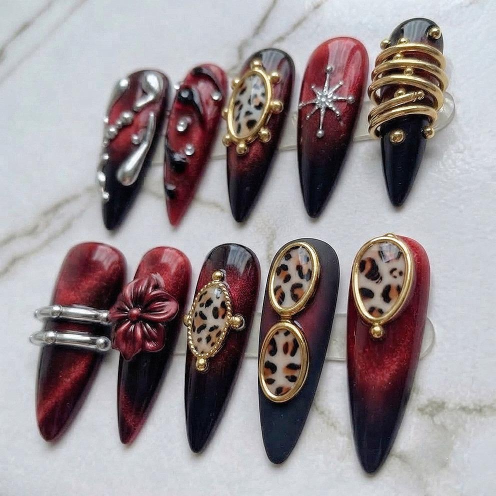 Burgundy and Black Cat-Eye Nails with Leopard Print, Metal Accents, and 3D Flower