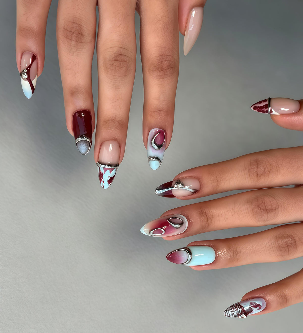 Burgundy and Blue Abstract Marbled Nails with Silver-Tone Metal Accents