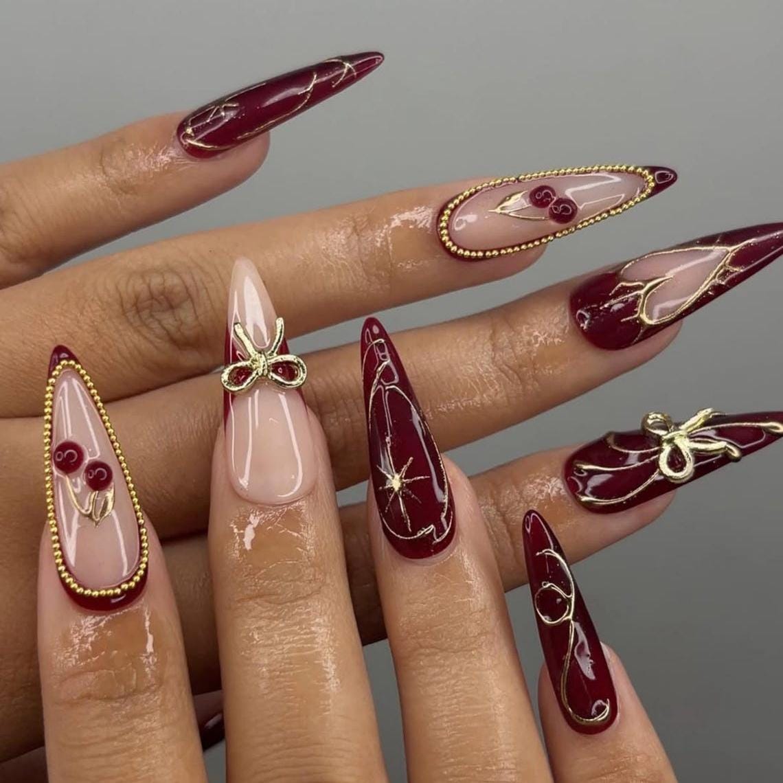 Burgundy and Blush Pink Nails with Gold Bows, Beaded Borders and Starbursts