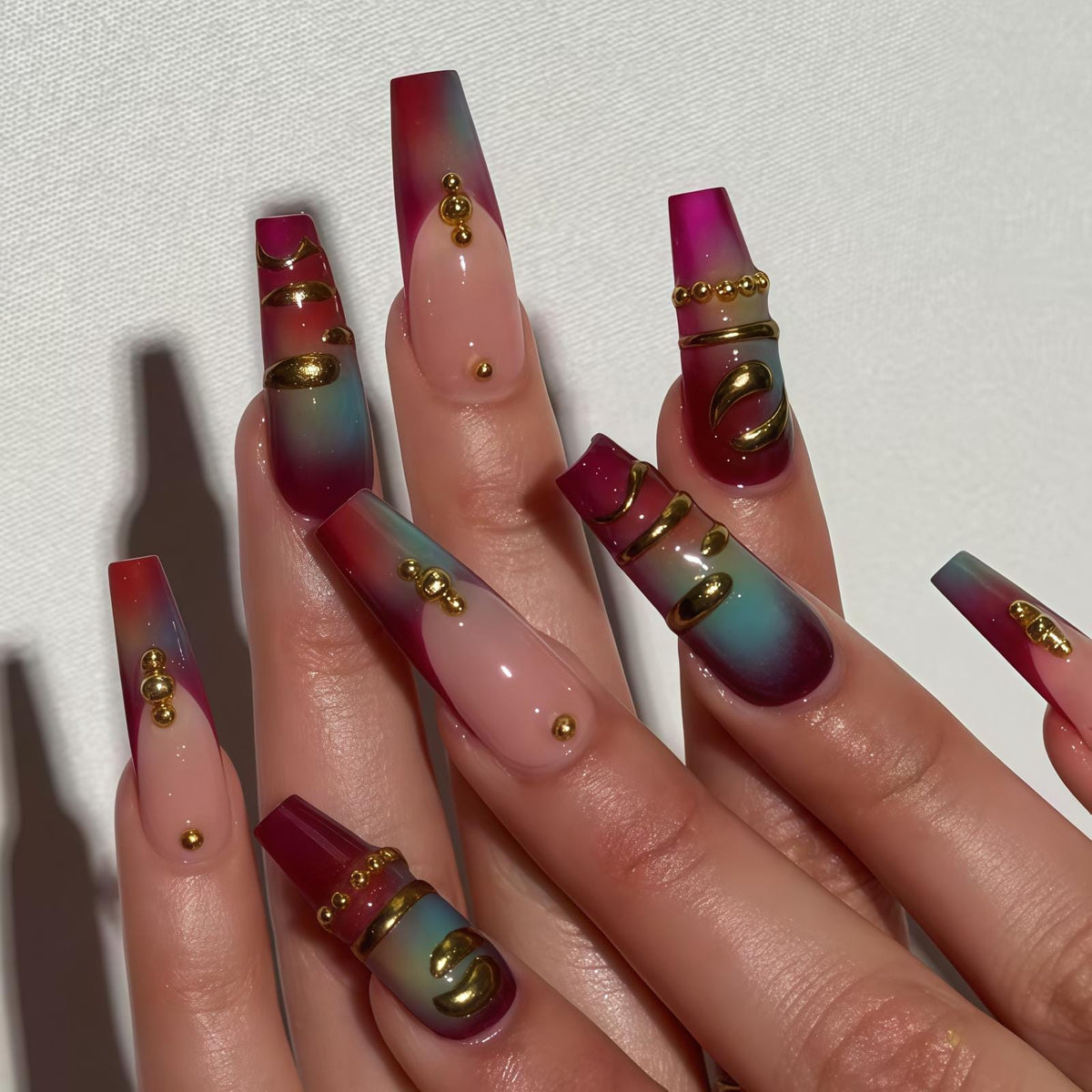 Burgundy and Teal Gradient Nails with Gold-Toned 3D Details