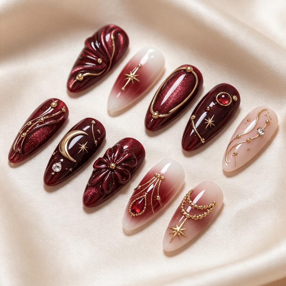 Burgundy Celestial Nail Set with Gold Moons, Starbursts, and Sculpted Flowers
