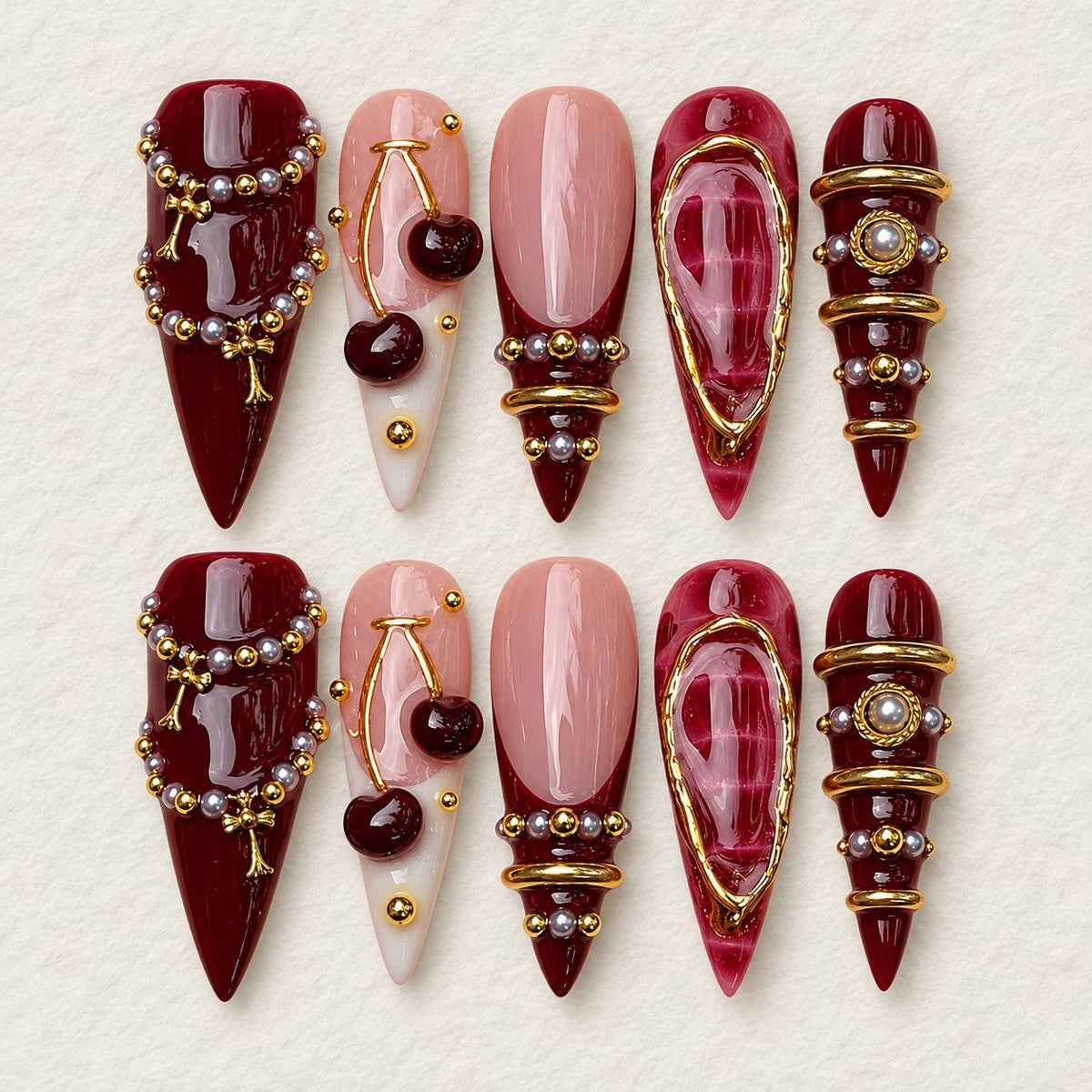 Burgundy Cherry Nails with Pearl Beads and Gold Jewelry Details
