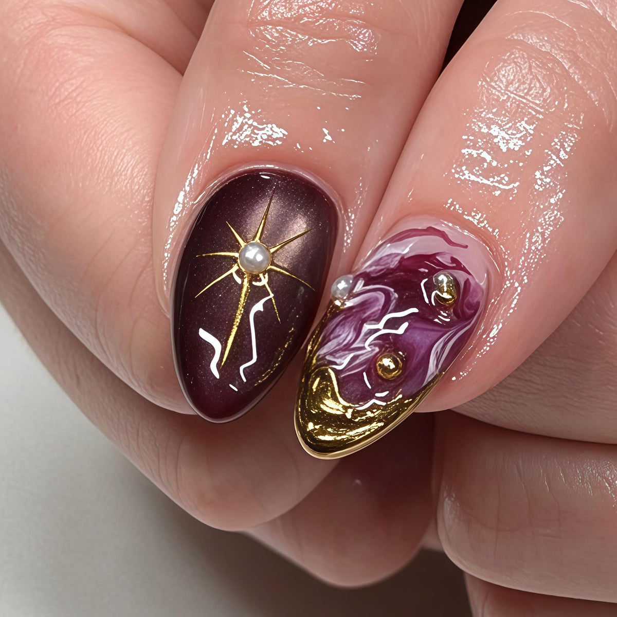 Burgundy Marble Nails with Gold Celestial Scrollwork and Pearl Details