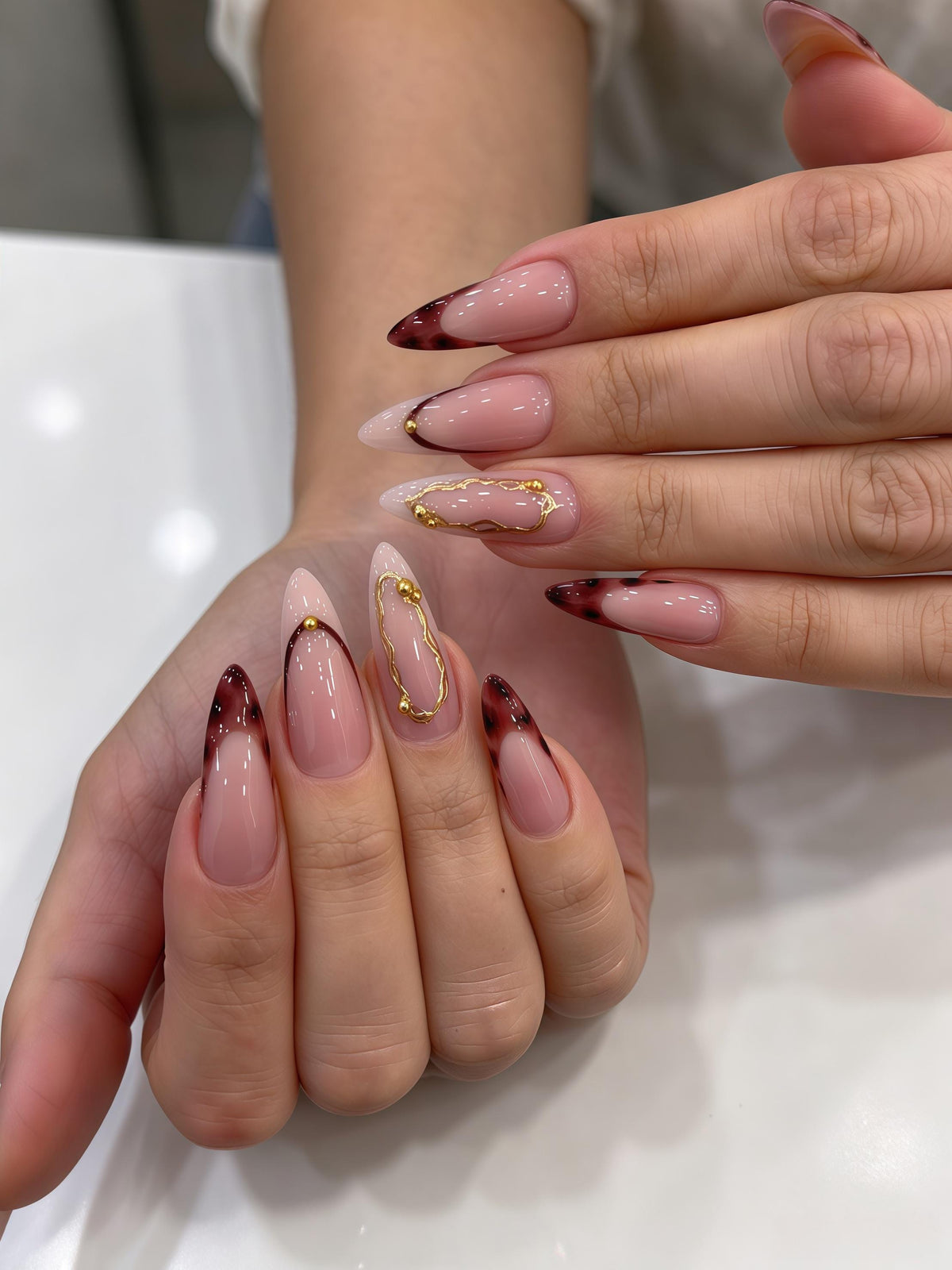 Burgundy Tortoiseshell French Tip Nails With Gold Chain Details