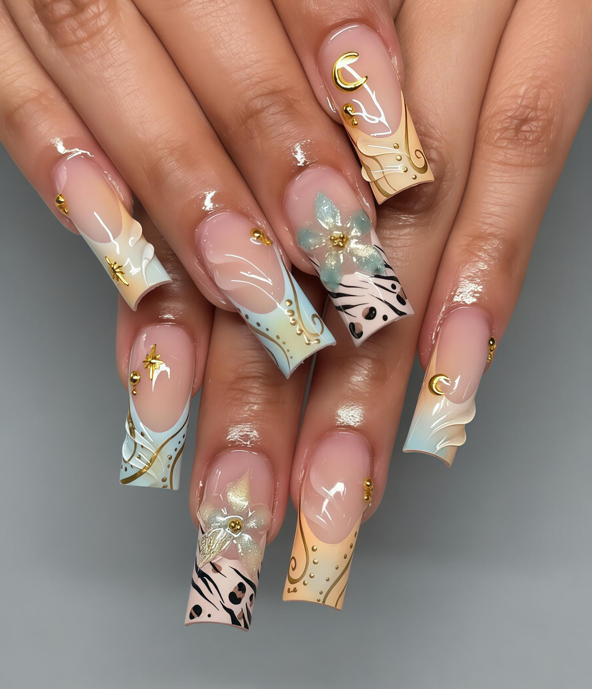 Celestial Moon and Star Nails with Gold Swirls, Blue Tips, Flowers and Gems