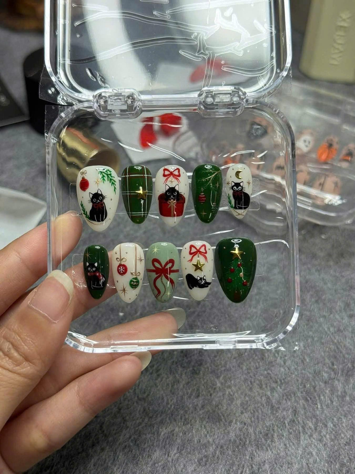 Christmas Cat Nails with Red Bows, Plaid, Ornaments, and Evergreen Details