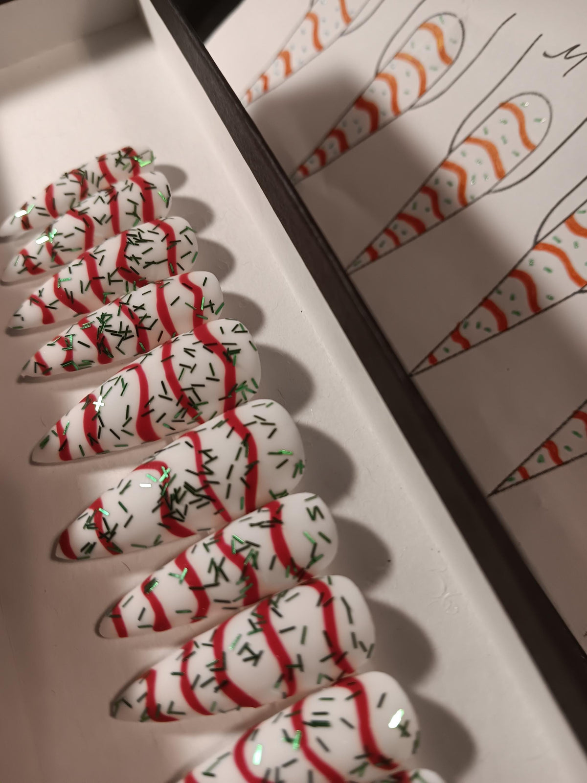 Christmas Tree Cake White Nails With Red Swirls and Green Sprigs