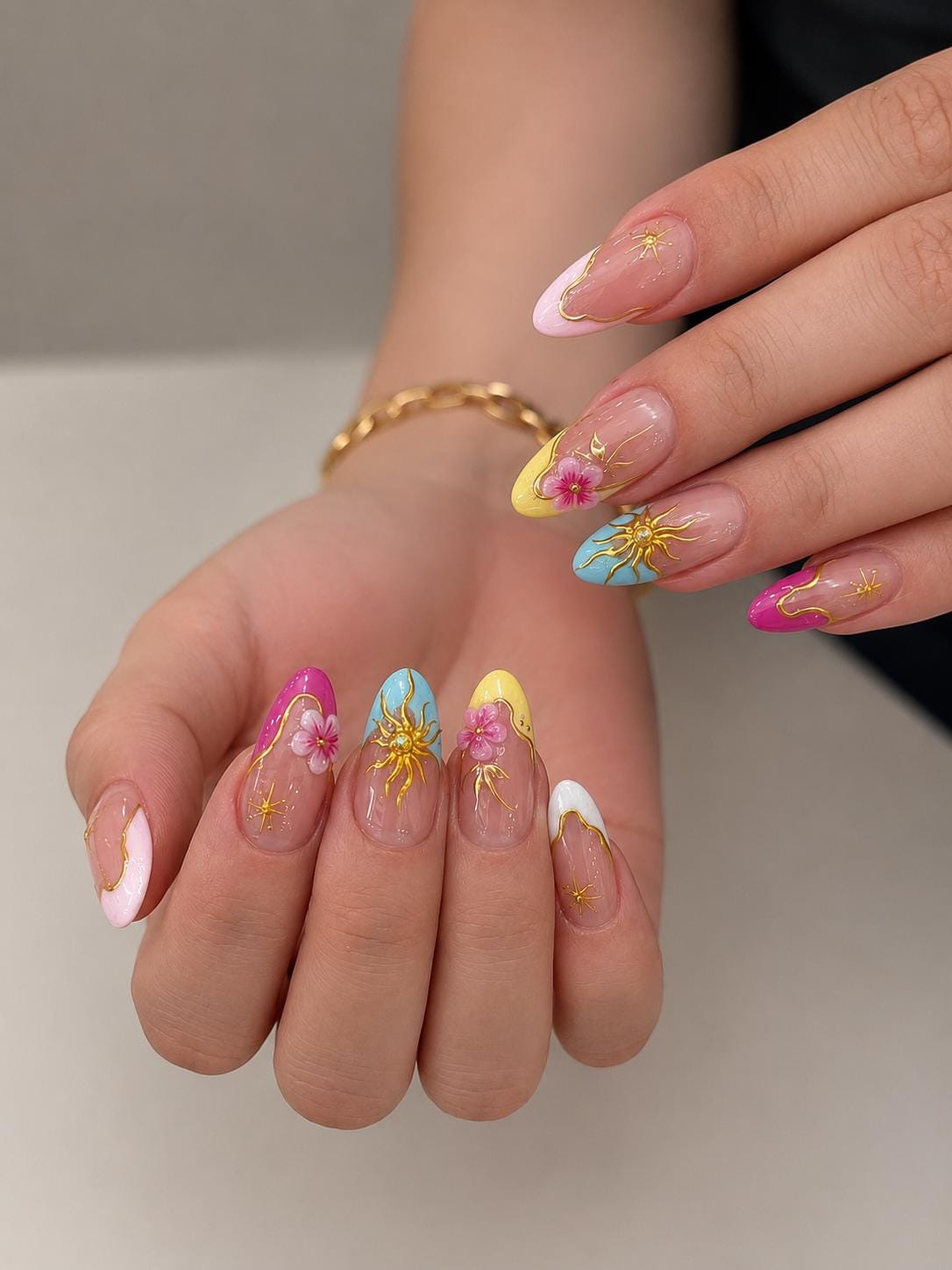 Colorful French Tip Nails With 3D Pink Flowers and Gold Starbursts