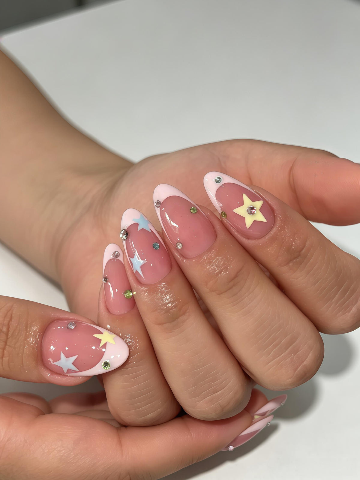 Dusty Rose French Tip Nails With Colorful Stars and Rhinestones