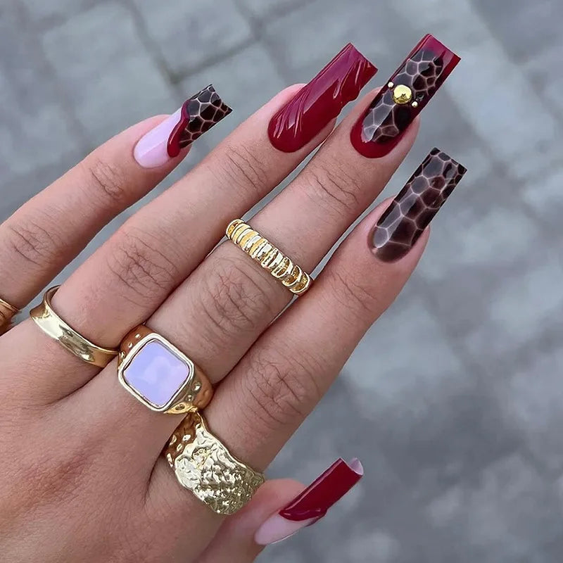 Glossy Red and Pink French Tip Nails with Honeycomb Pattern and Gold Charm