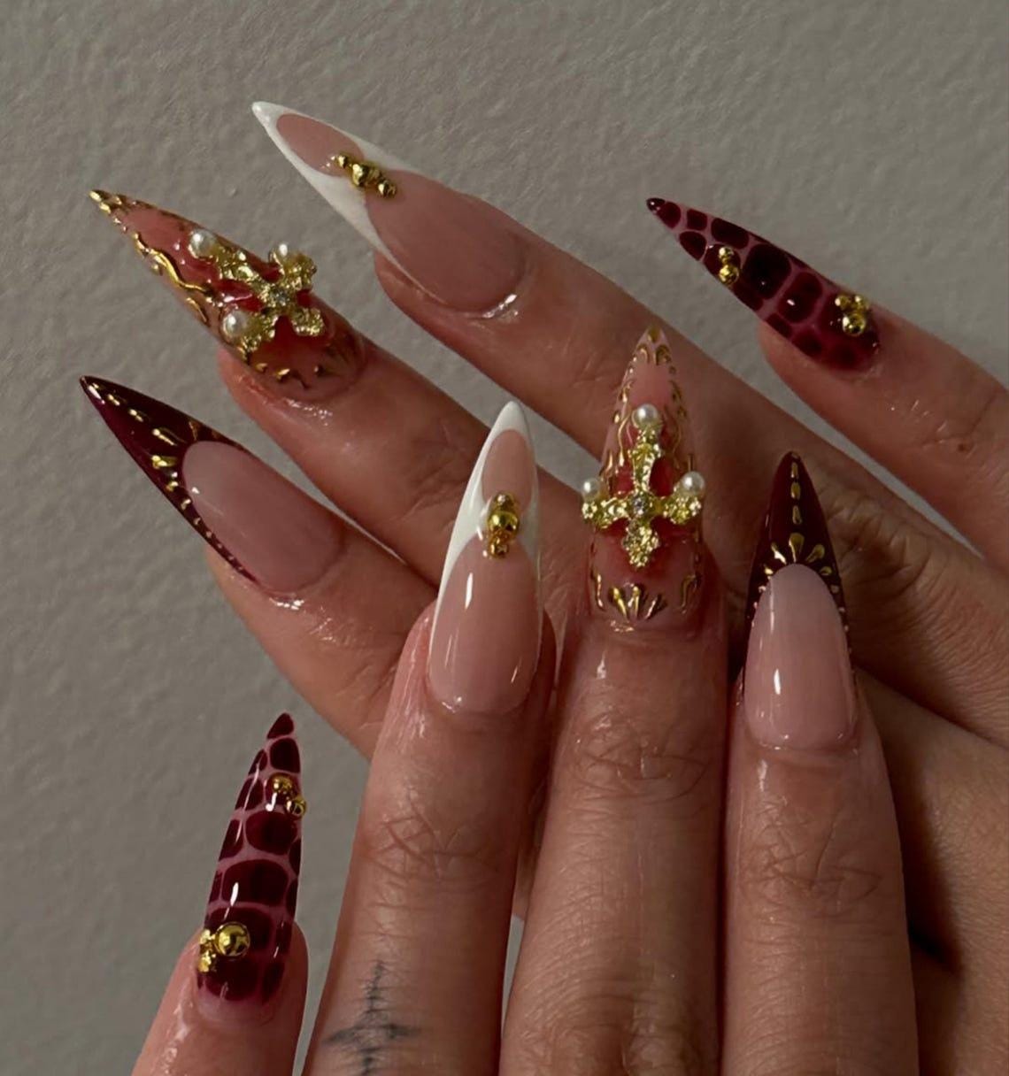 Gothic Burgundy and Nude Nails with Gold Cross and Rhinestone Details