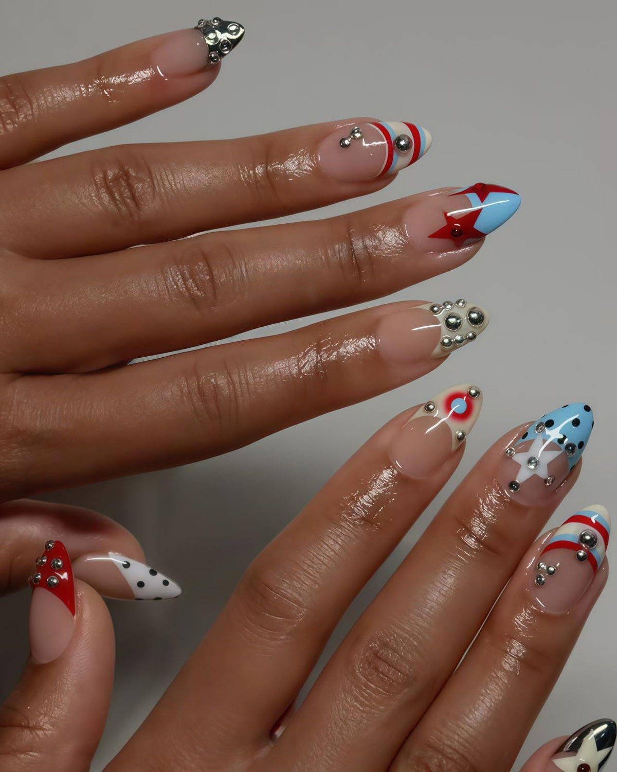 Graphic Star and Striped French Tip Nails with Silver Charms