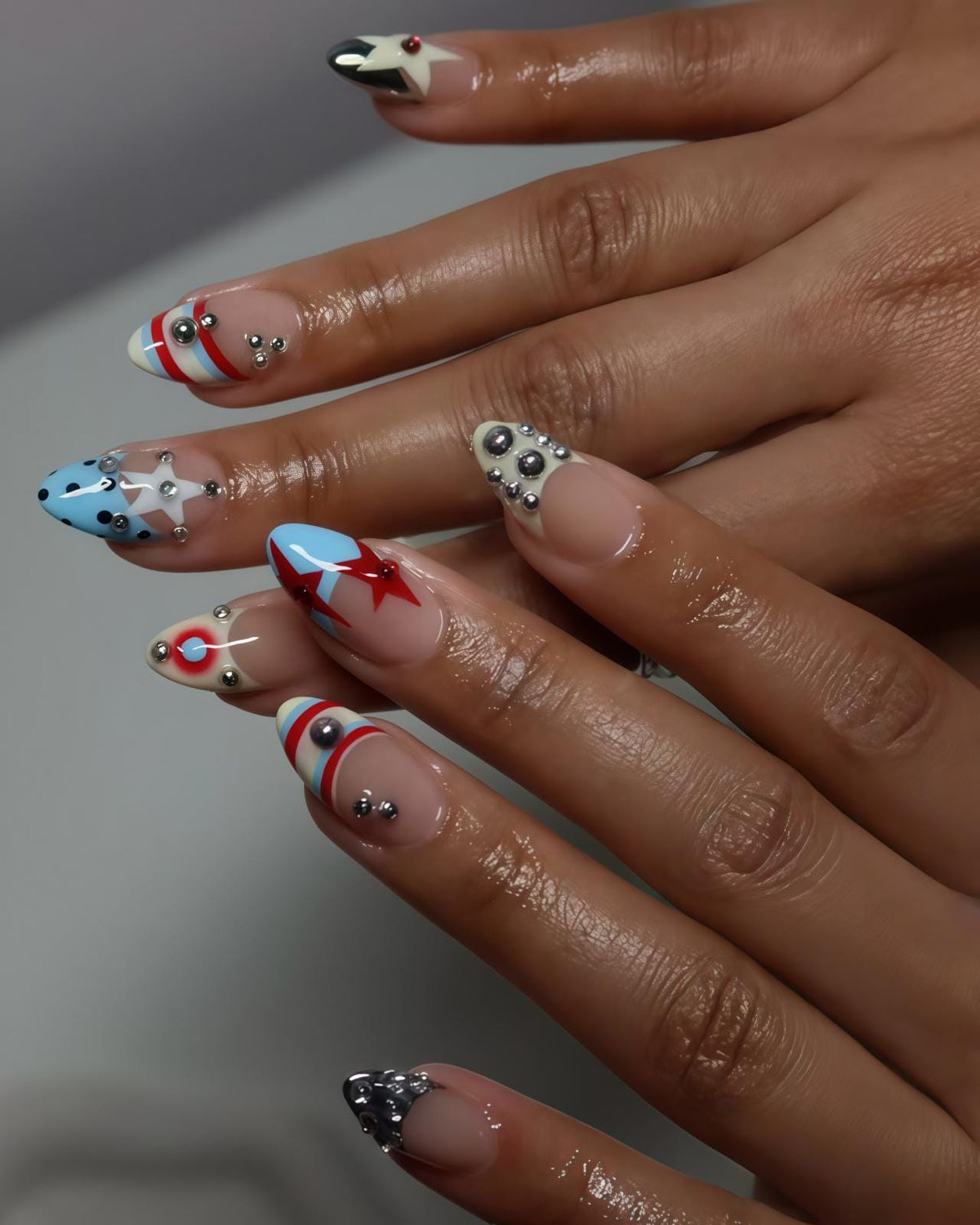 Graphic Star and Striped French Tip Nails with Silver Charms