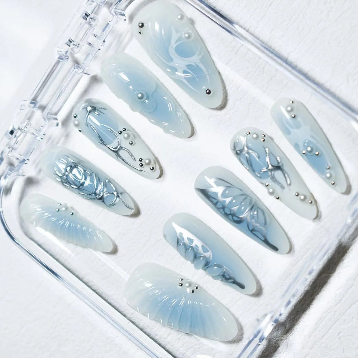 Icy Blue Sculpted Wing and Shell Nail Set With Silver Chrome Details