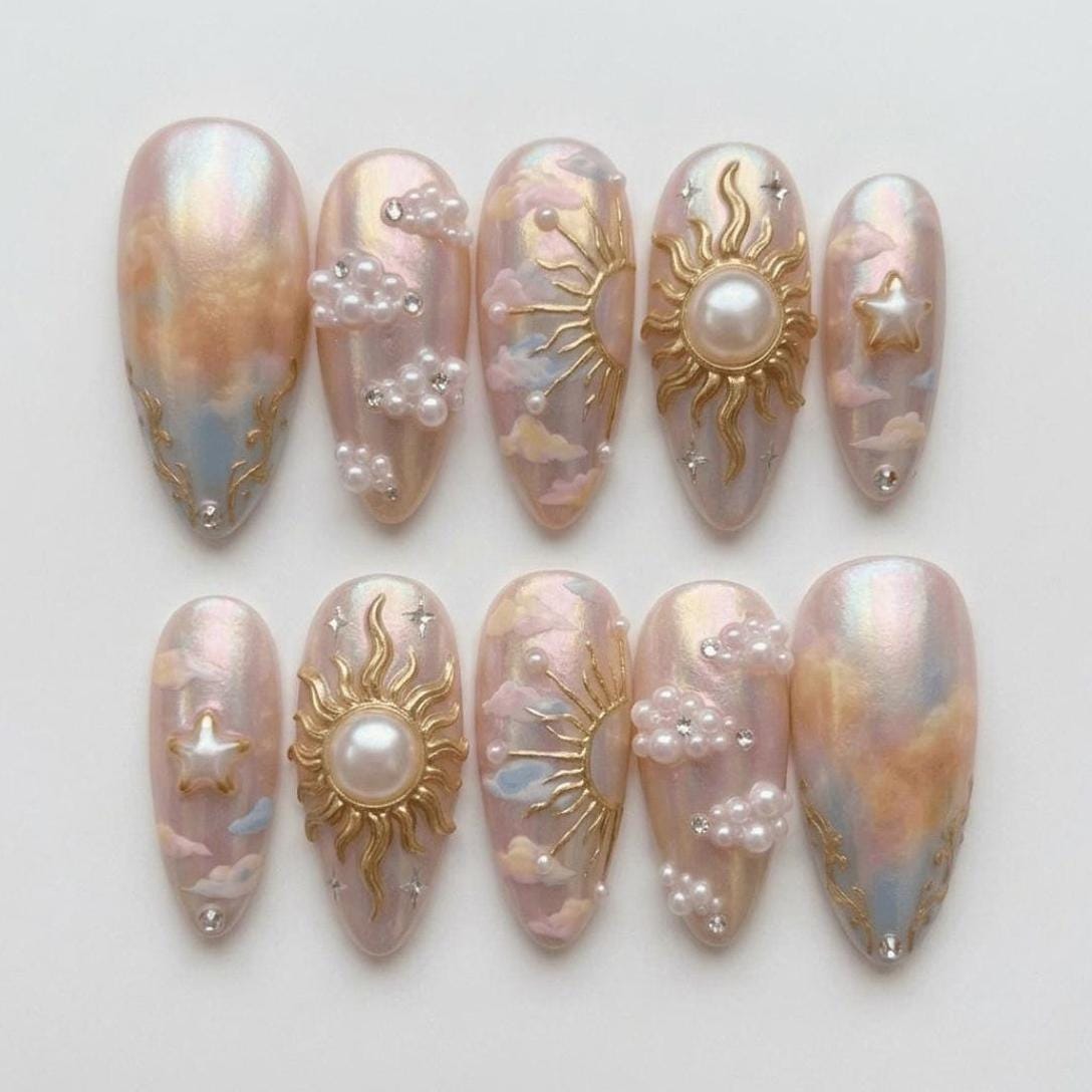 Iridescent Pink Cloud Marble Nails With Gold Sunbursts and Pearls