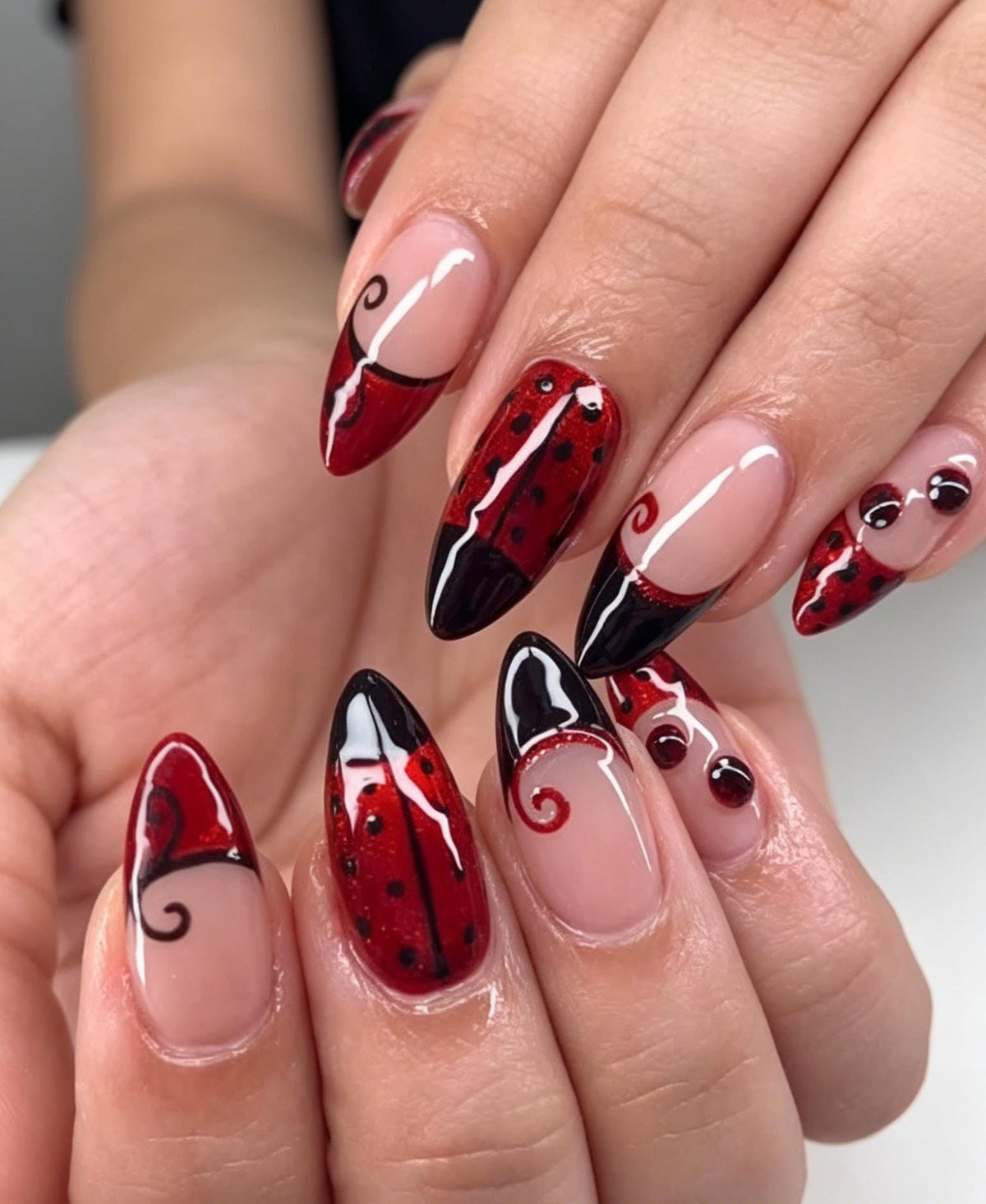 Ladybug-Inspired Red and Black Nail Set with Nude-Pink Base