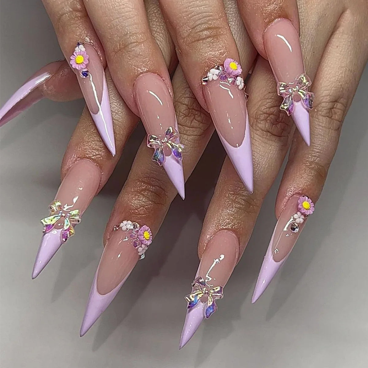 Lilac French Tip Nails With Floral Accents and Iridescent Butterfly Charms