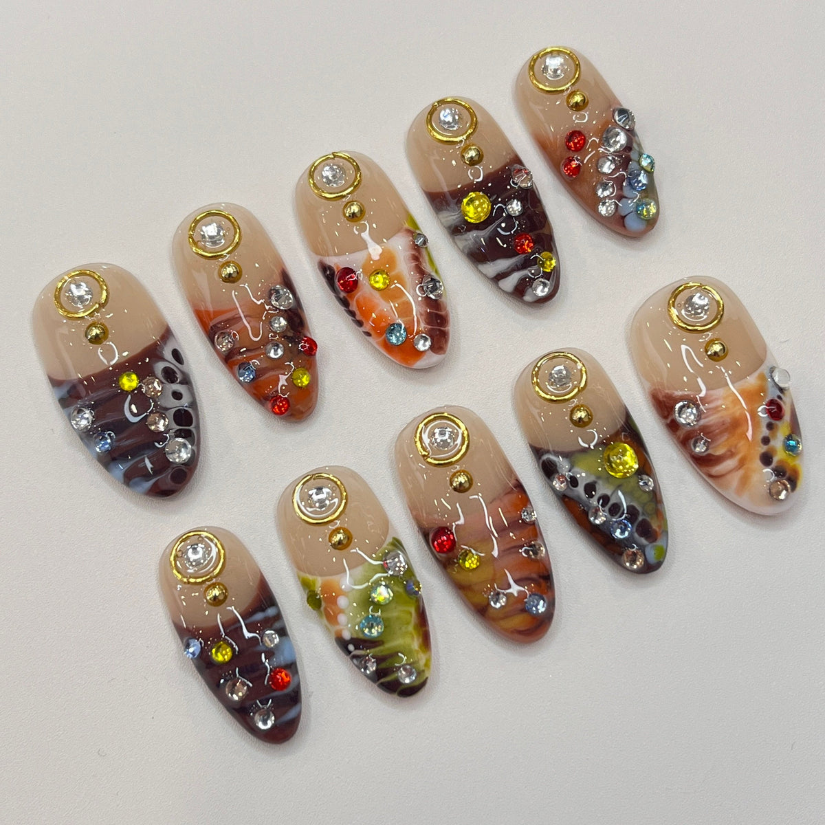 Marbled Swirl Press-On Nails with Gold-Rimmed Stones and Colorful Rhinestones