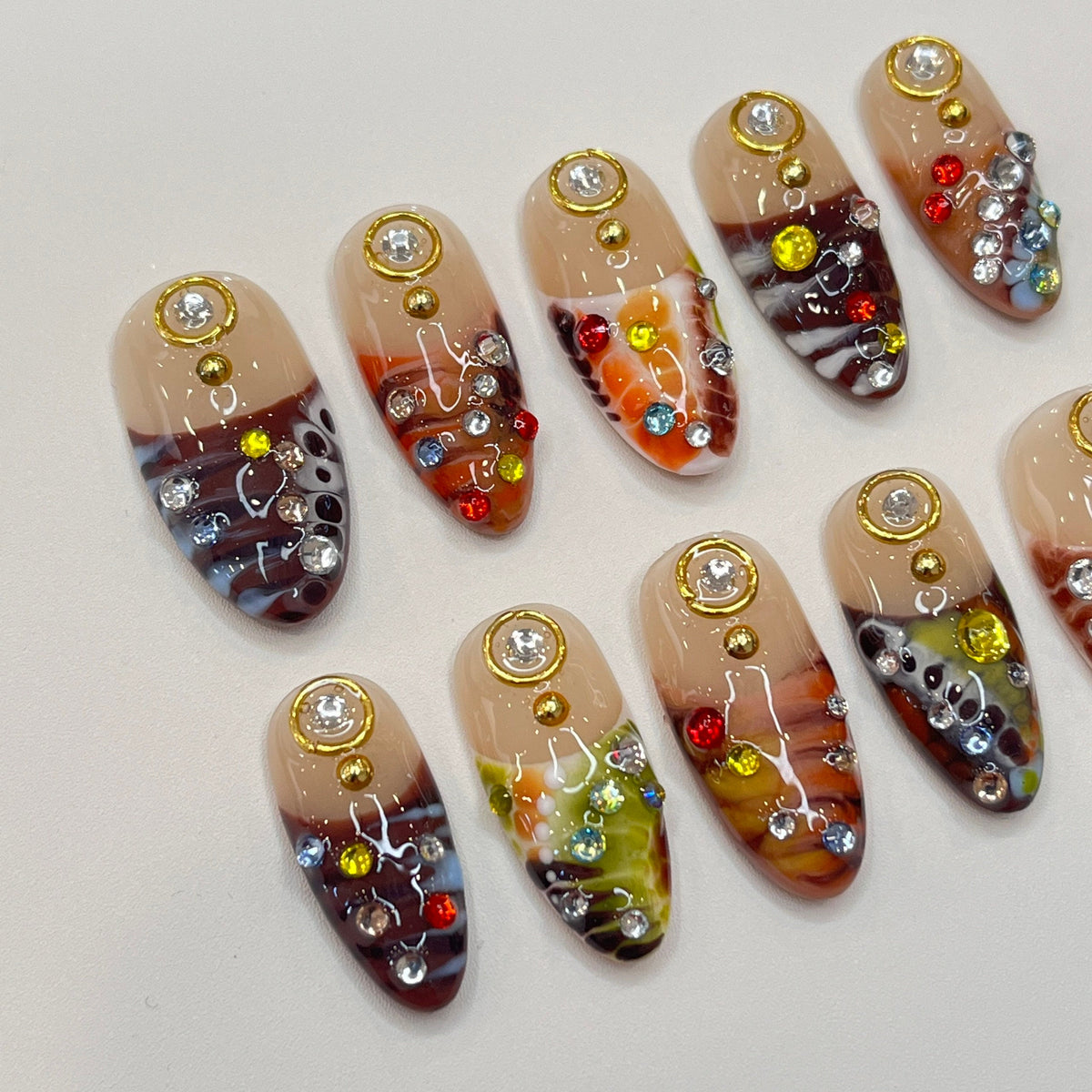 Marbled Swirl Press-On Nails with Gold-Rimmed Stones and Colorful Rhinestones