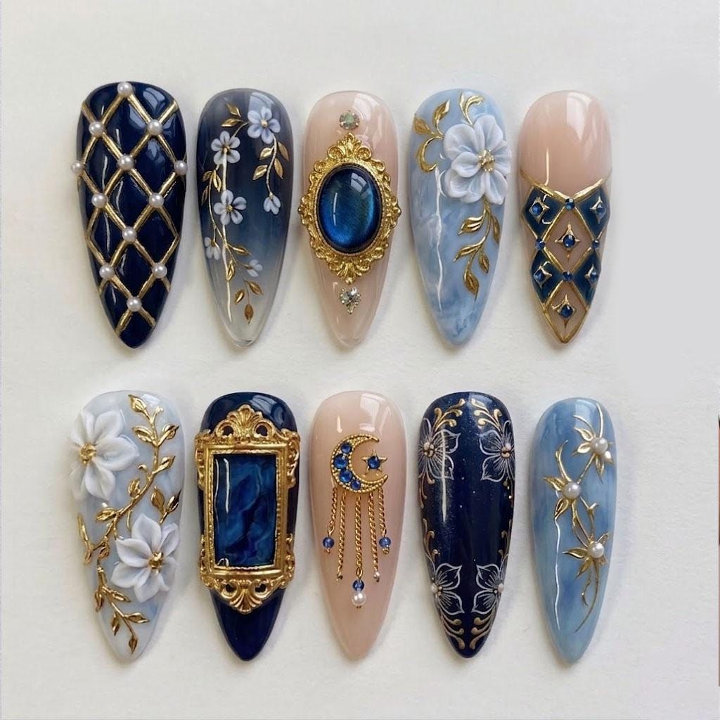 Navy and Pale Blue Nails With Gold Floral, Pearl, and Gem Details