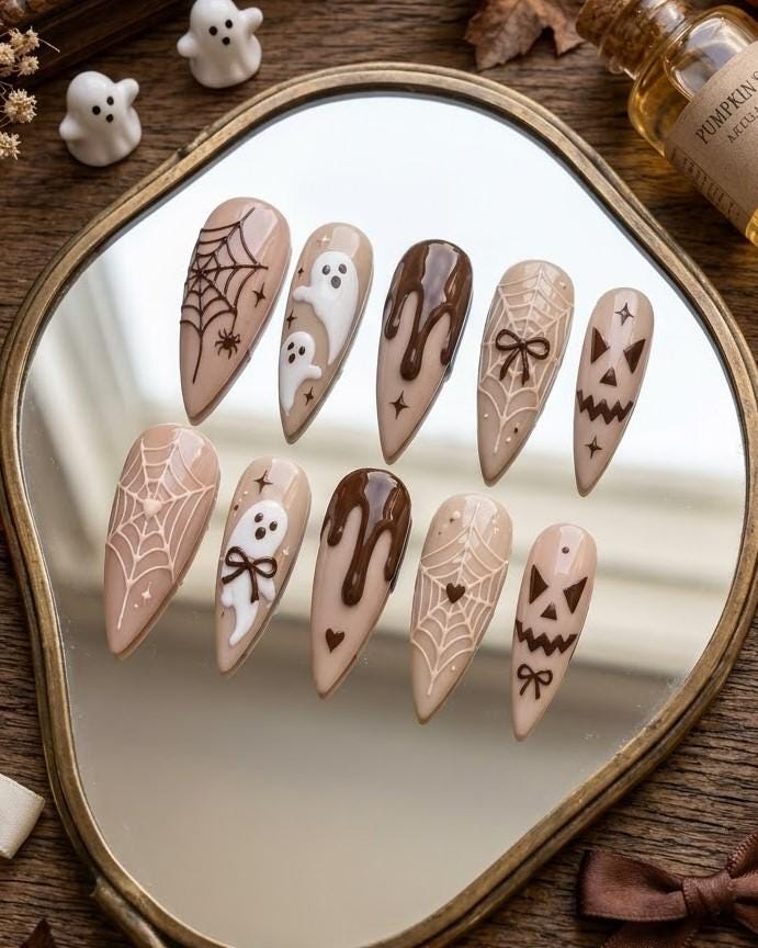 Neutral Brown Halloween Nails With Ghosts, Spiderwebs, Bows, and Jack-O’-Lantern Faces