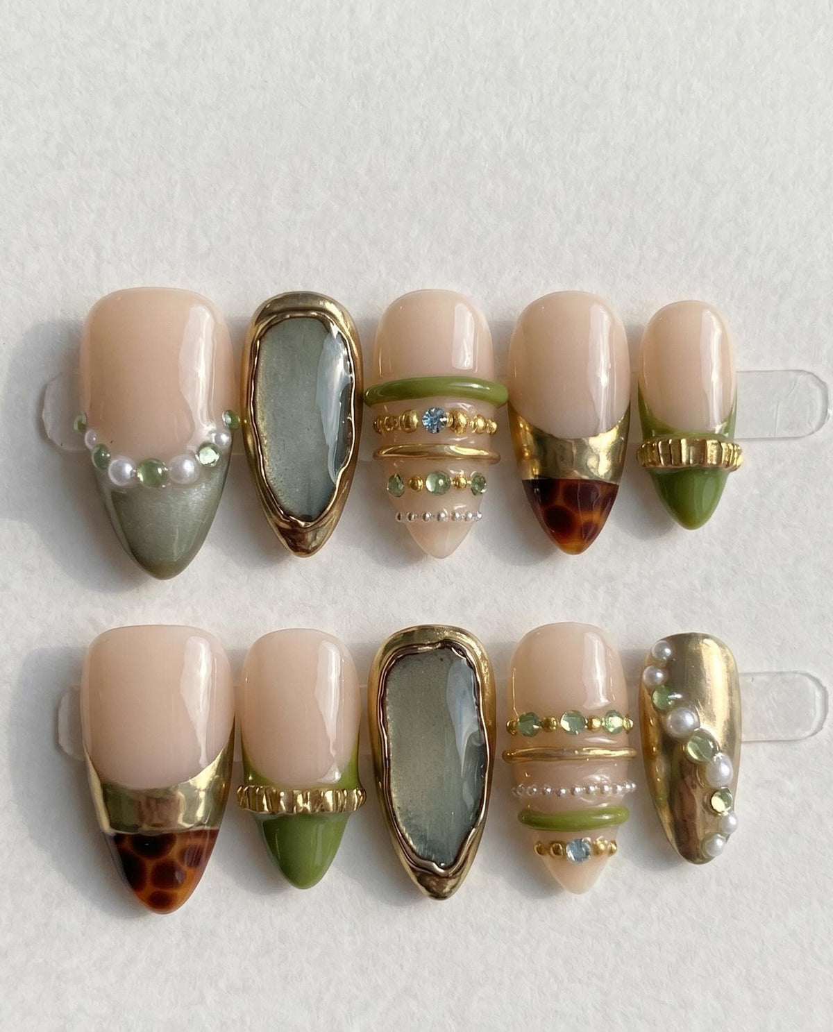 Nude Beige Press-On Nails With Gold Chrome Bangles, Tortoiseshell Tips and Green Gem Details