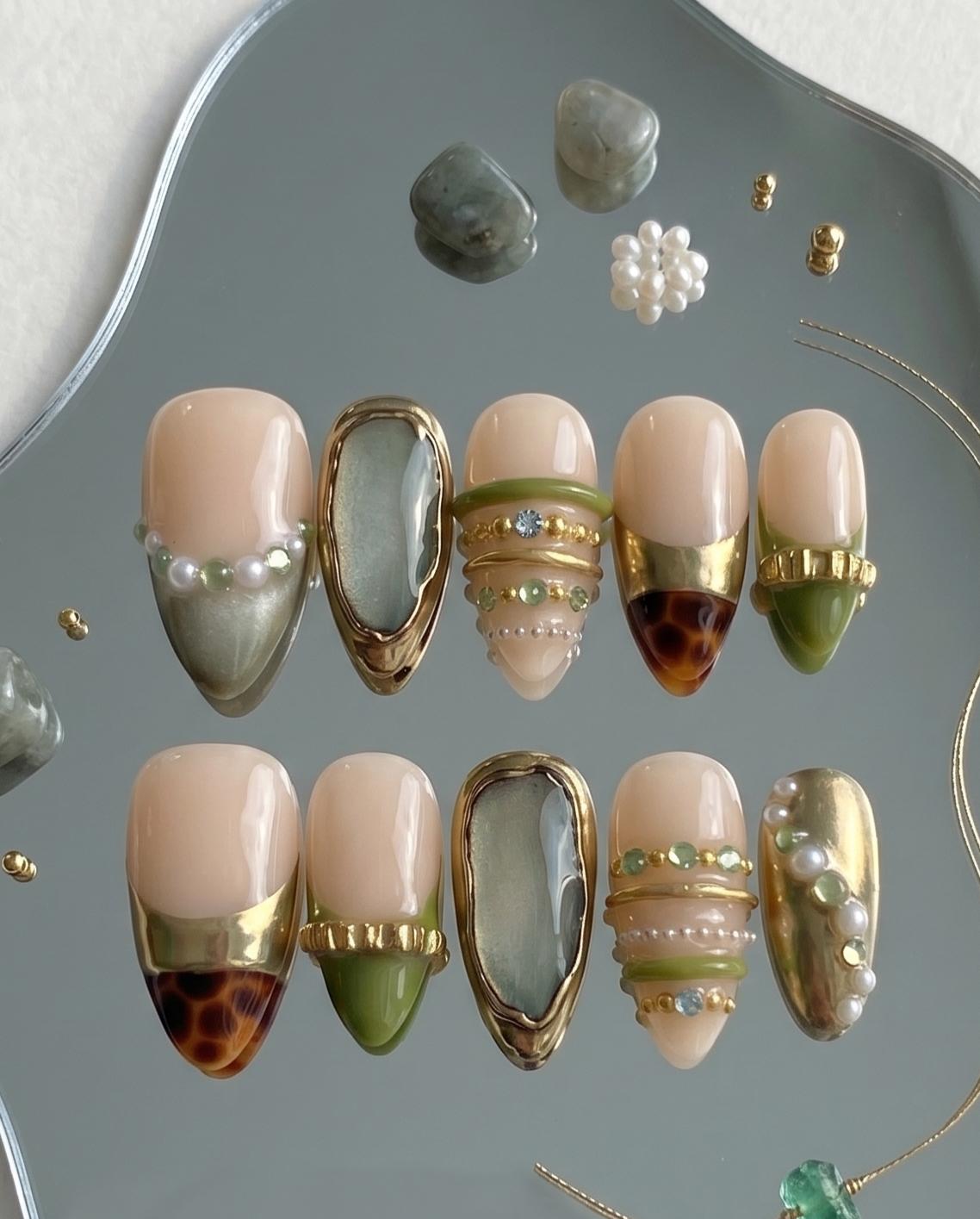 Nude Beige Press-On Nails With Gold Chrome Bangles, Tortoiseshell Tips and Green Gem Details